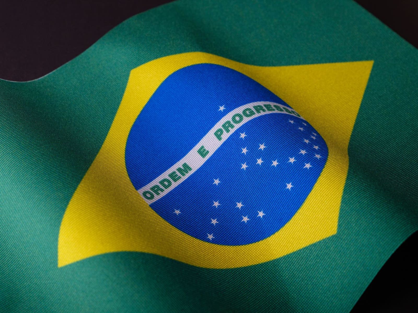 Close-up of the Brazilian national flag waving outdoors