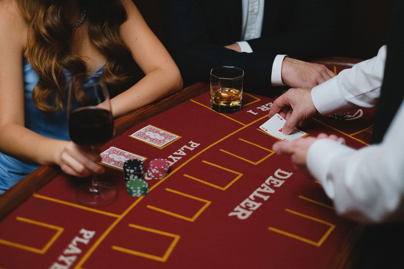 A blackjack table with dealer and chips inside a casino