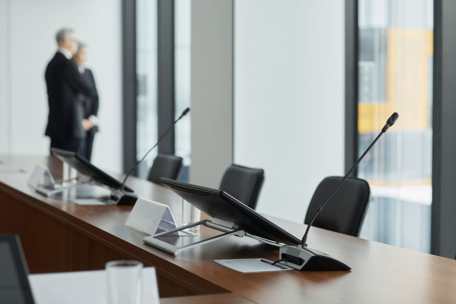 Executives seated around a boardroom table during a strategy meeting