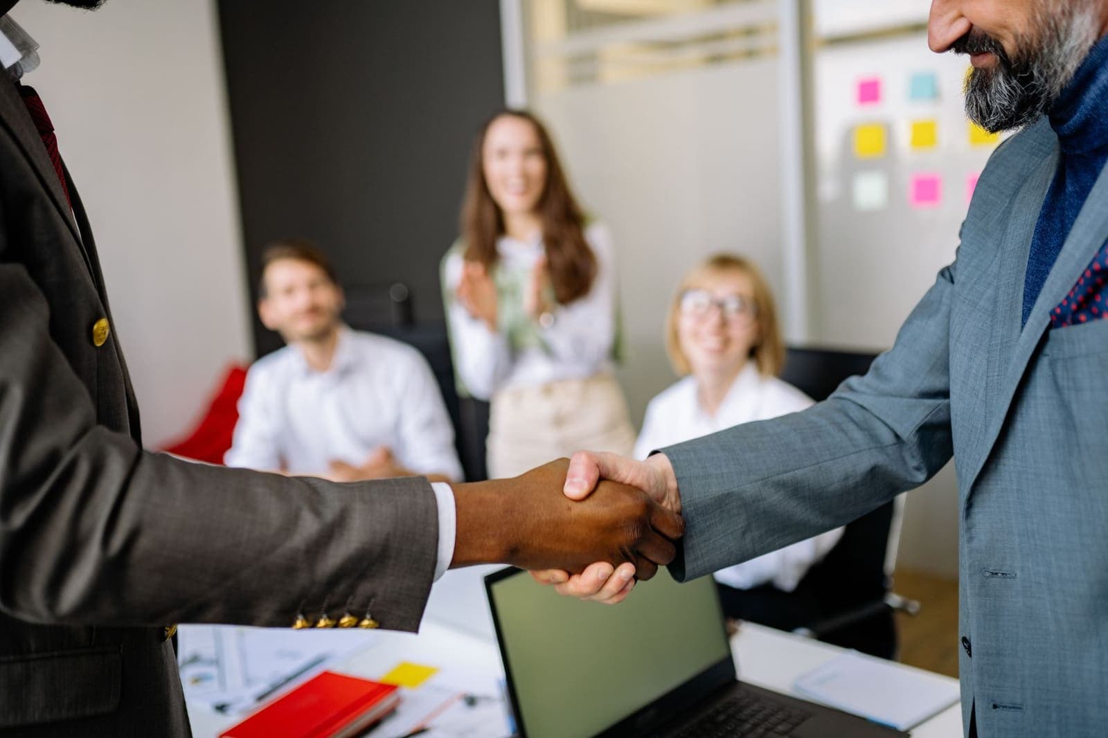 Two business executives shaking hands in an office setting