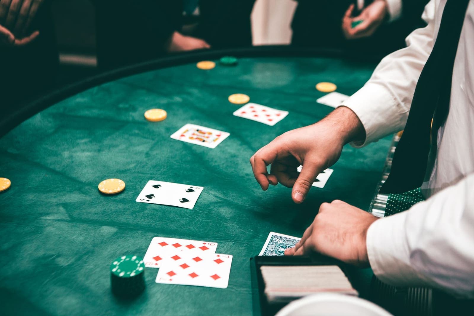 cards being dealt at a blackjack table