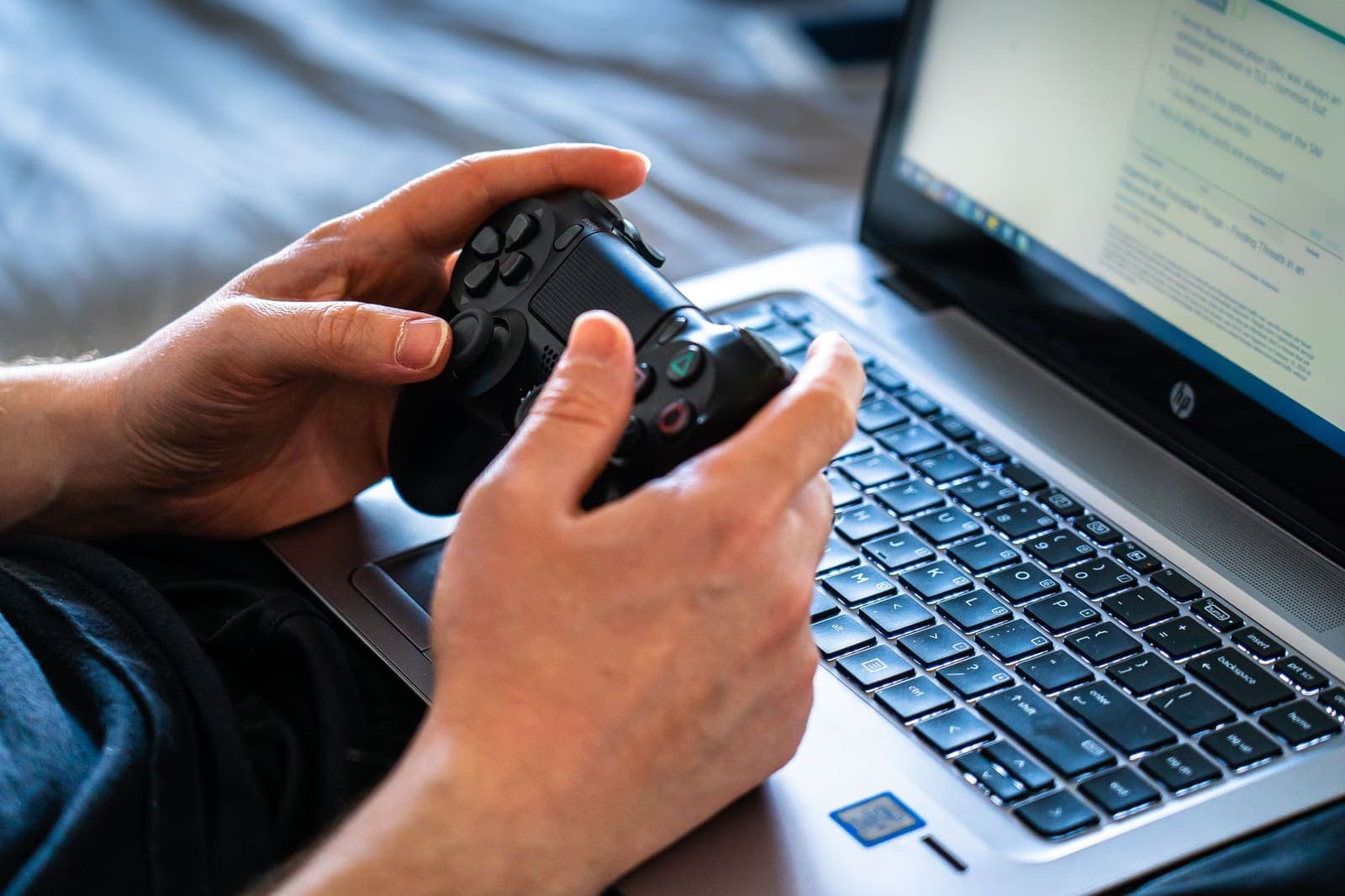 Person using a laptop to play an online slot game at home