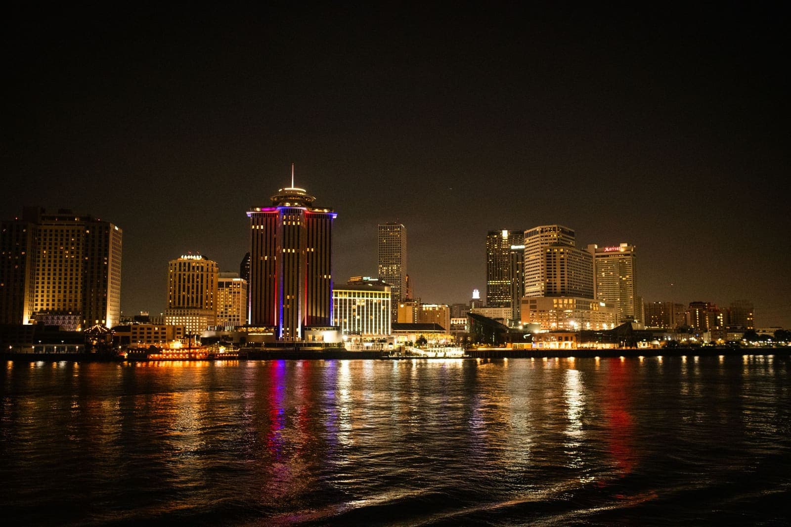 A riverside casino resort building under a clear sky