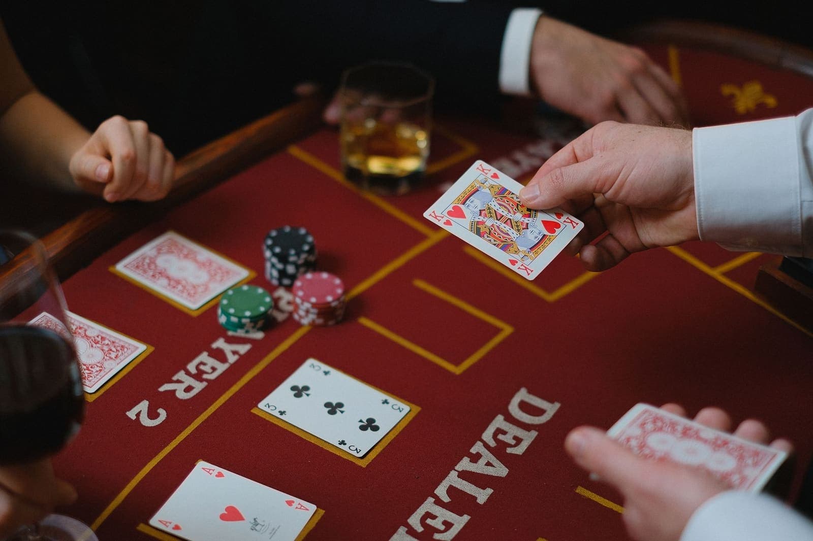 Royal flush of spades fanned out on a green poker table beside chips