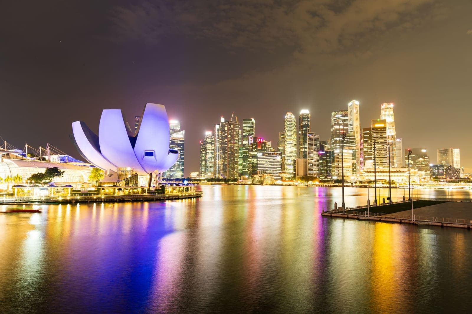 Singapore's skyline lit up at night including waterfront buildings
