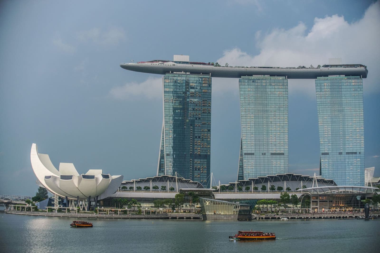 Exterior view of an integrated casino resort in Singapore at dusk