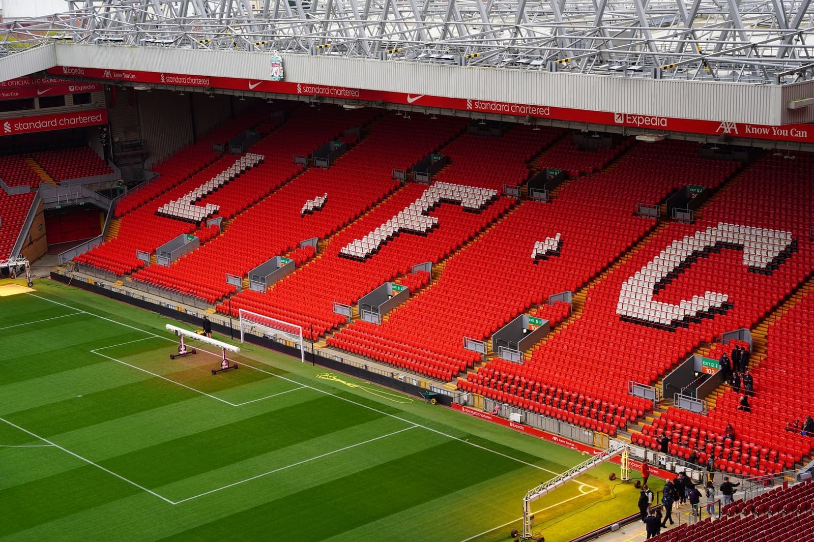 Football stadium pitch with sponsor branding visible around the perimeter